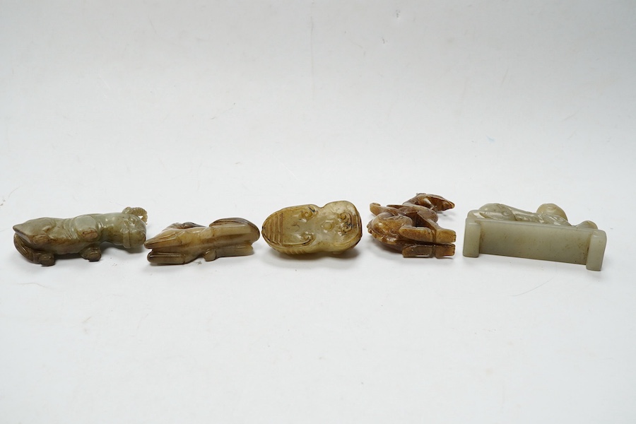 Four Chinese jade carvings, of a horse, cicada, a winged beast, a kneeling man, and a horned beast, longest 7cm. Condition - good